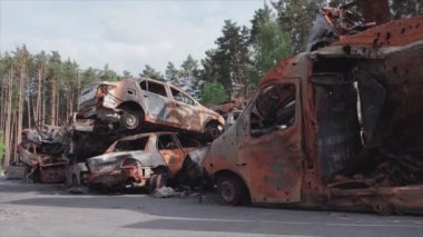 This stock video shows a dump of shot and burned cars in Irpin, Bucha district in 8K resolution