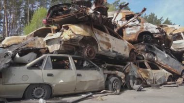 This stock video shows a dump of shot and burned cars in Irpin, Bucha district in 8K resolution