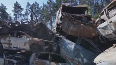 This stock video shows a dump of shot and burned cars in Irpin, Bucha district in 8K resolution