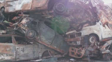 This stock video shows a dump of shot and burned cars in Irpin, Bucha district in 8K resolution