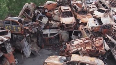 This stock video shows a dump of shot and burned cars in Irpin, Bucha district in 8K resolution