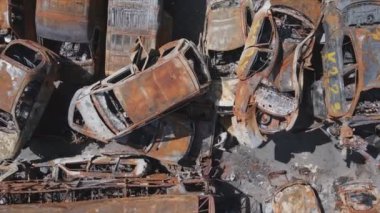 This stock video shows a dump of shot and burned cars in Irpin, Bucha district in 8K resolution