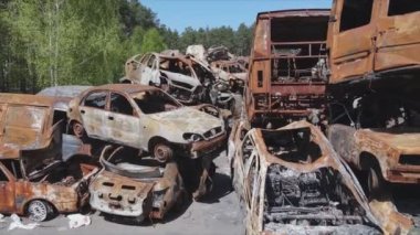 This stock video shows a dump of shot and burned cars in Irpin, Bucha district in 8K resolution