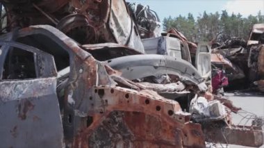 This stock video shows a dump of shot and burned cars in Irpin, Bucha district in 8K resolution