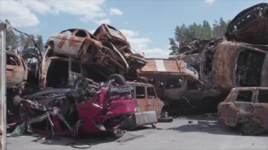 This stock video shows a dump of shot and burned cars in Irpin, Bucha district in 8K resolution