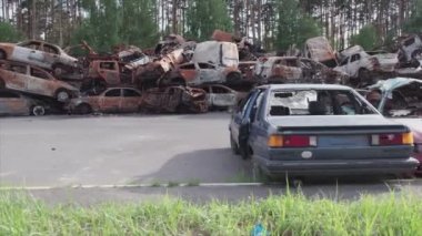 This stock video shows a dump of shot and burned cars in Irpin, Bucha district in 8K resolution