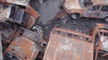 This stock video shows a dump of shot and burned cars in Irpin, Bucha district in 8K resolution