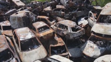 This stock video shows a dump of shot and burned cars in Irpin, Bucha district in 8K resolution