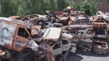 This stock video shows a dump of shot and burned cars in Irpin, Bucha district in 8K resolution