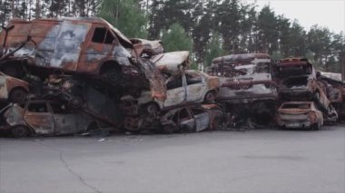 This stock video shows a dump of shot and burned cars in Irpin, Bucha district in 8K resolution