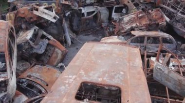 This stock video shows a dump of shot and burned cars in Irpin, Bucha district in 8K resolution