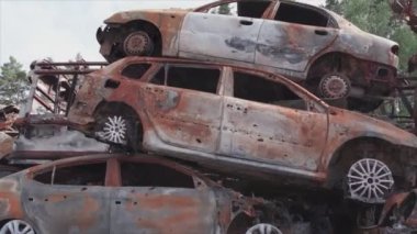 This stock video shows a dump of shot and burned cars in Irpin, Bucha district in 8K resolution