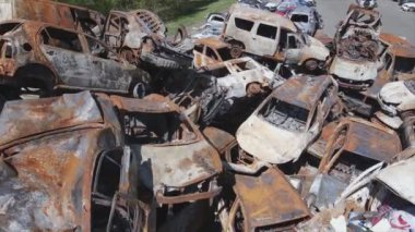 This stock video shows a dump of shot and burned cars in Irpin, Bucha district in 8K resolution