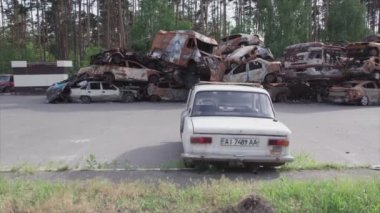 This stock video shows a dump of shot and burned cars in Irpin, Bucha district in 8K resolution