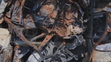 This stock video shows a dump of shot and burned cars in Irpin, Bucha district in 8K resolution