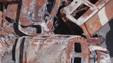 This stock video shows a dump of shot and burned cars in Irpin, Bucha district in 8K resolution