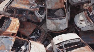 This stock video shows a dump of shot and burned cars in Irpin, Bucha district in 8K resolution