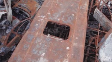 This stock video shows a dump of shot and burned cars in Irpin, Bucha district in 8K resolution