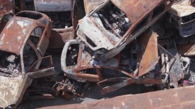 This stock video shows a dump of shot and burned cars in Irpin, Bucha district in 8K resolution