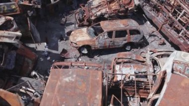 This stock video shows a dump of shot and burned cars in Irpin, Bucha district in 8K resolution