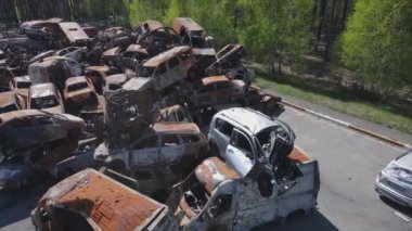 This stock video shows a dump of shot and burned cars in Irpin, Bucha district in 8K resolution