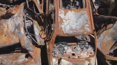 This stock video shows a dump of shot and burned cars in Irpin, Bucha district in 8K resolution