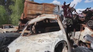 This stock video shows a dump of shot and burned cars in Irpin, Bucha district in 8K resolution