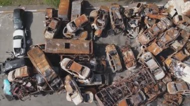 This stock video shows a dump of shot and burned cars in Irpin, Bucha district in 8K resolution