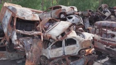 This stock video shows a dump of shot and burned cars in Irpin, Bucha district in 8K resolution