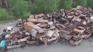 This stock video shows a dump of shot and burned cars in Irpin, Bucha district in 8K resolution
