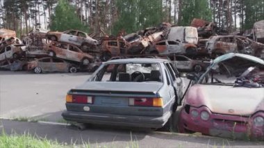 This stock video shows a dump of shot and burned cars in Irpin, Bucha district in 8K resolution