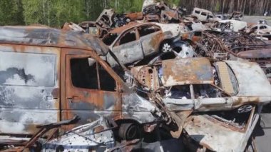 This stock video shows a dump of shot and burned cars in Irpin, Bucha district in 8K resolution