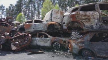 This stock video shows a dump of shot and burned cars in Irpin, Bucha district in 8K resolution