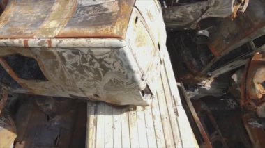 This stock video shows a dump of shot and burned cars in Irpin, Bucha district in 8K resolution