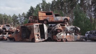 This stock video shows a dump of shot and burned cars in Irpin, Bucha district in 8K resolution
