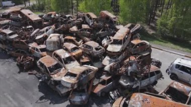 This stock video shows a dump of shot and burned cars in Irpin, Bucha district in 8K resolution