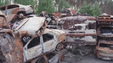 This stock video shows a dump of shot and burned cars in Irpin, Bucha district in 8K resolution