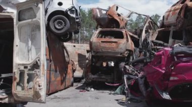 This stock video shows a dump of shot and burned cars in Irpin, Bucha district in 8K resolution