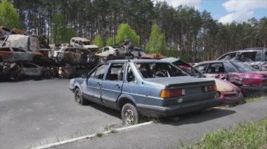 This stock video shows a dump of shot and burned cars in Irpin, Bucha district in 8K resolution