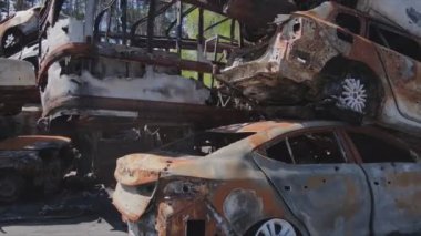 This stock video shows a dump of shot and burned cars in Irpin, Bucha district in 8K resolution