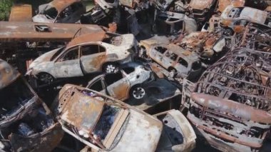 This stock video shows a dump of shot and burned cars in Irpin, Bucha district in 8K resolution