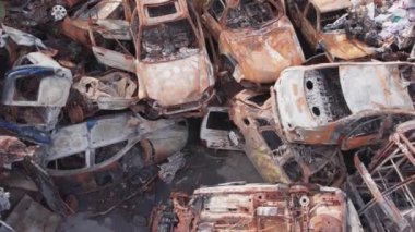 This stock video shows a dump of shot and burned cars in Irpin, Bucha district in 8K resolution