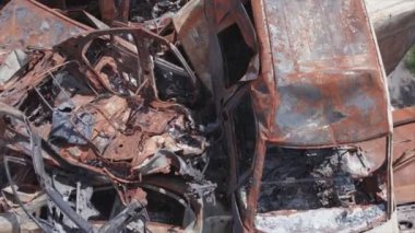 This stock video shows a dump of shot and burned cars in Irpin, Bucha district in 8K resolution