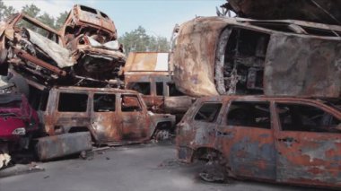This stock video shows a dump of shot and burned cars in Irpin, Bucha district in 8K resolution