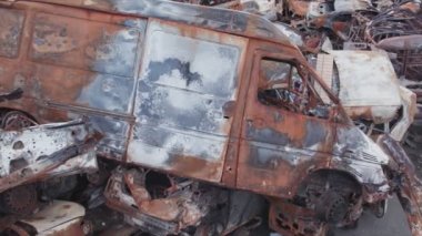 This stock video shows a dump of shot and burned cars in Irpin, Bucha district in 8K resolution