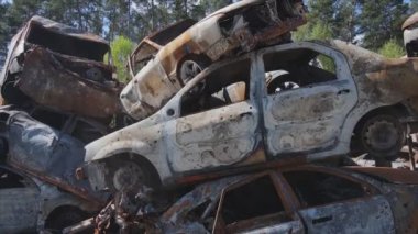 This stock video shows a dump of shot and burned cars in Irpin, Bucha district in 8K resolution