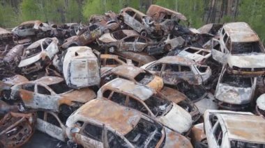 This stock video shows a dump of shot and burned cars in Irpin, Bucha district in 8K resolution