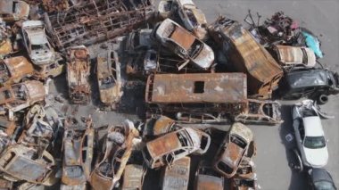 This stock video shows a dump of shot and burned cars in Irpin, Bucha district in 8K resolution