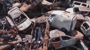 This stock video shows a dump of shot and burned cars in Irpin, Bucha district in 8K resolution