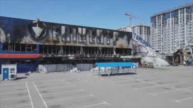 This stock video shows a destroyed building of a shopping center in Bucha, Ukraine during the war in 8K resolution